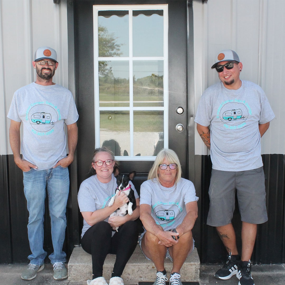 Glenpool Camper Sales & Storage team with dog at office entrance
