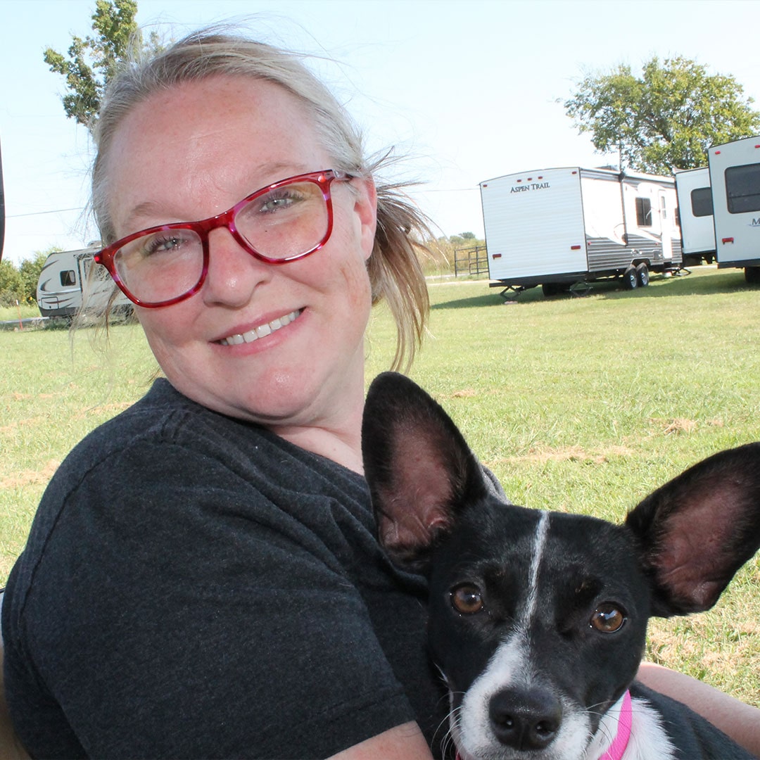 Glenpool Camper Sales & Storage team member with dog at RV lot